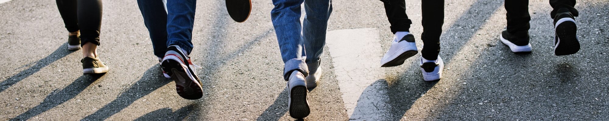 Image of people's feet walking on pavement